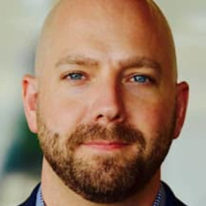 Portrait of Dr. Matt Newlin, First-Generation College Graduate and Higher Education Consultant
