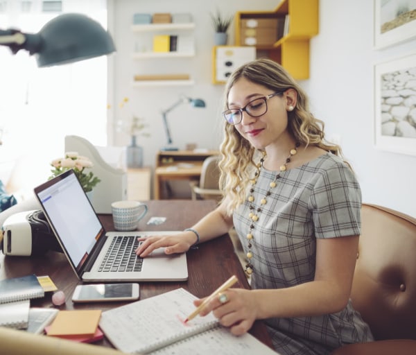 Woman working at desk on laptop