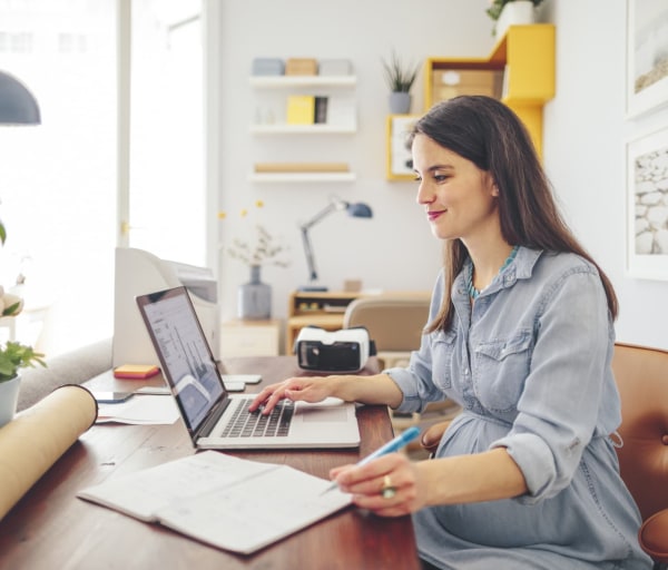 Woman working on laptop showing a graph