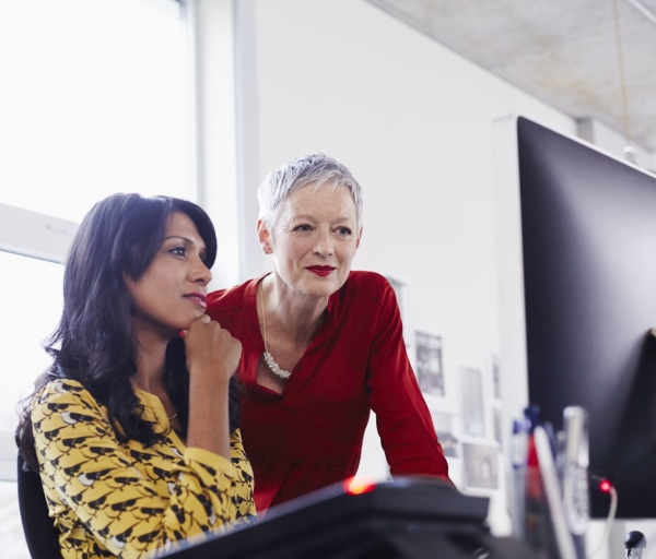 Two people working together on a computer