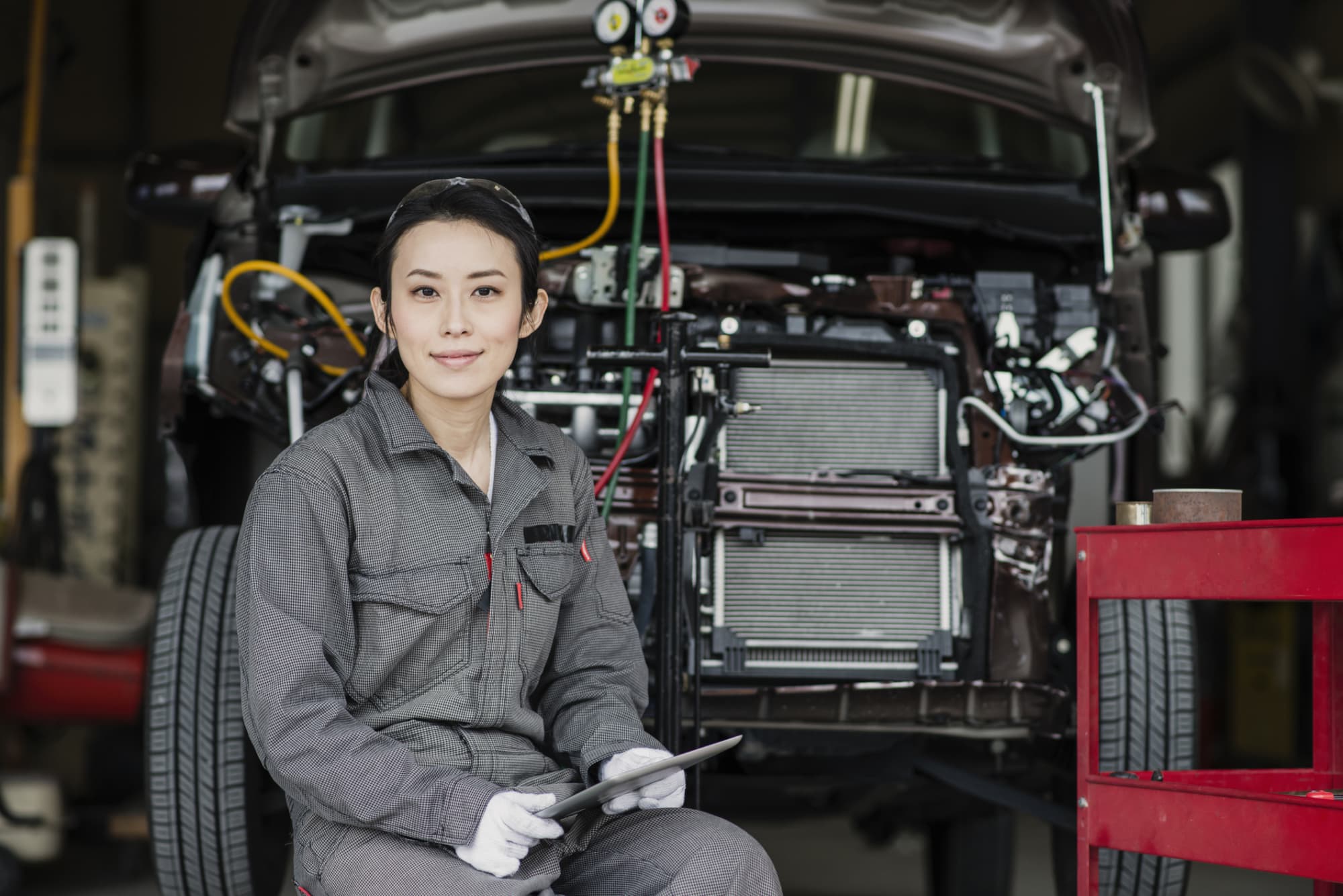 Woman mechanic in a car garage