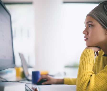 Woman using desktop computer in office