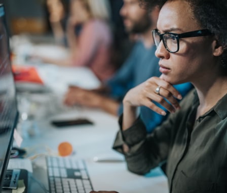 Woman looking at code on computer