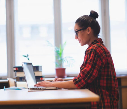 Young woman working on her laptop at home. Image Credit: mihailomilovanovic / E+ / Getty Images