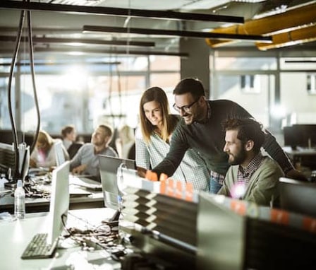 Group of colleagues working together on a computer