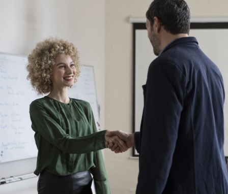 Man and woman shaking hands in an office