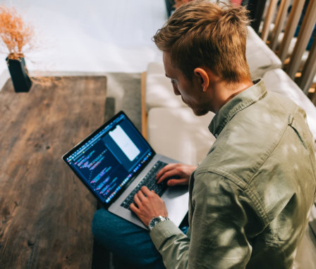 Person coding an app on a laptop