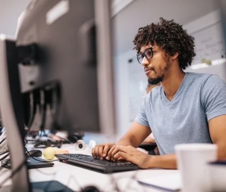 Man typing on computer keyboard