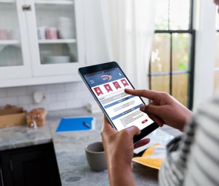 A woman uses a digital tablet to review her ballot and vote online in the comfort of her home. Image Credit: SDI Productions / E+ / Getty Images