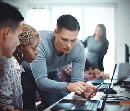 Colleagues working together on a laptop computer