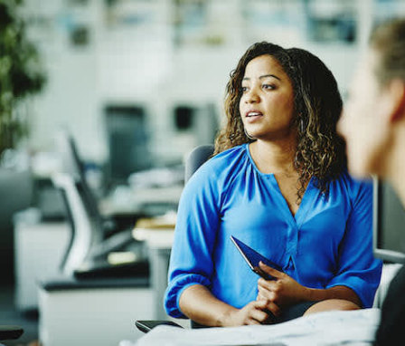 Woman talking with colleagues in office