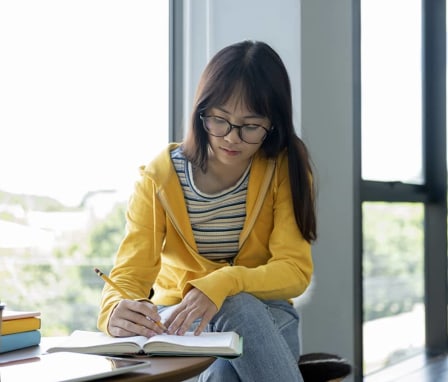 Girl writing in book