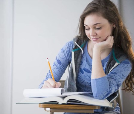 Girl writing on notepad