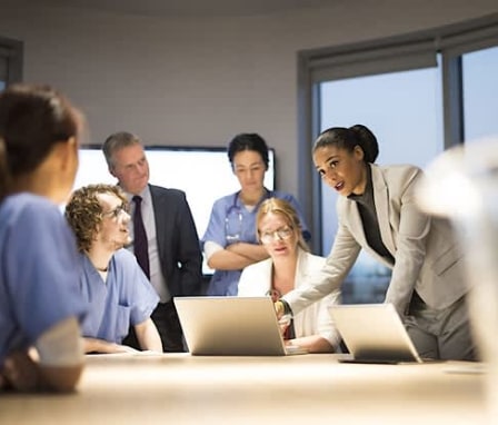 Medical workers meeting around table