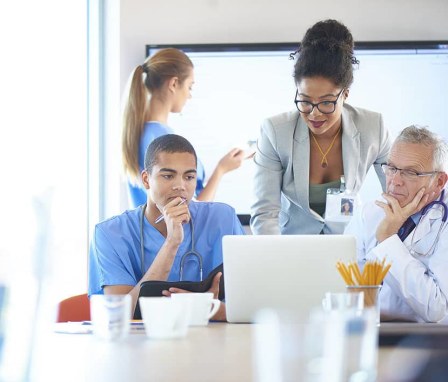 Doctors looking at laptop