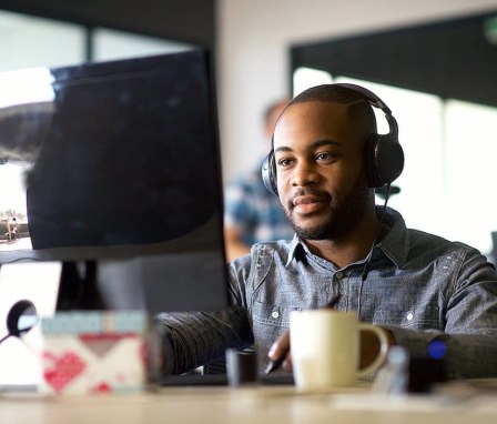 Man wearing headphones at computer