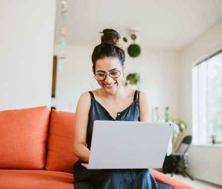 Smiling woman typing on laptop