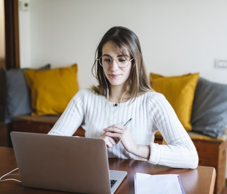 Person looking at laptop screen at a desk