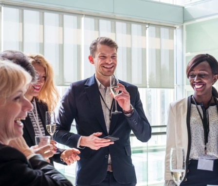 Businesspeople chatting at a Chamber of Commerce social event. Image Credit: Ales-A / E+ / Getty Images