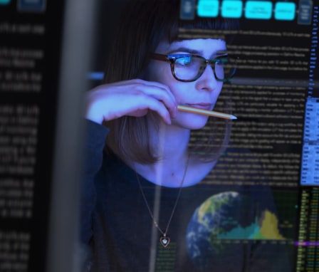 Woman focusing on code on computer screen