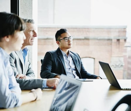 Three business colleagues in a meeting together