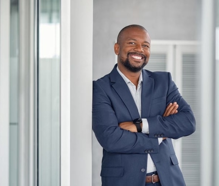 Man in suit smiling and posing for camera