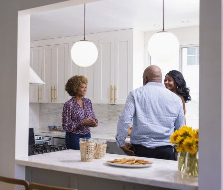 Real estate agent showing kitchen to couple