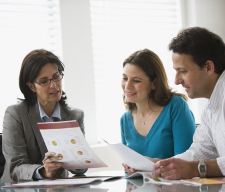 Woman with couple looking at graphs