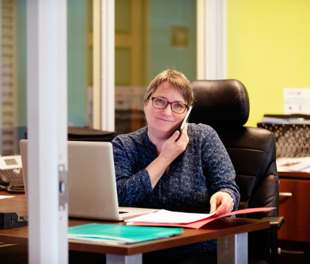 Woman on the phone working at a desk