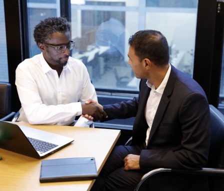 Two men shaking hands in a business meeting