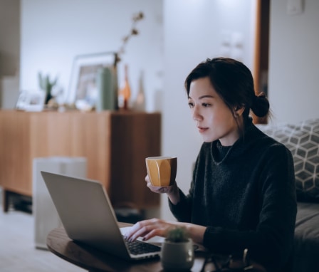 Woman working on laptop at home
