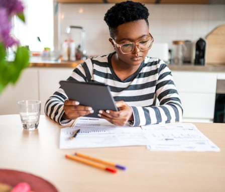 Person studying charts and holding a tablet