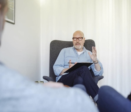 Therapist talking to patient