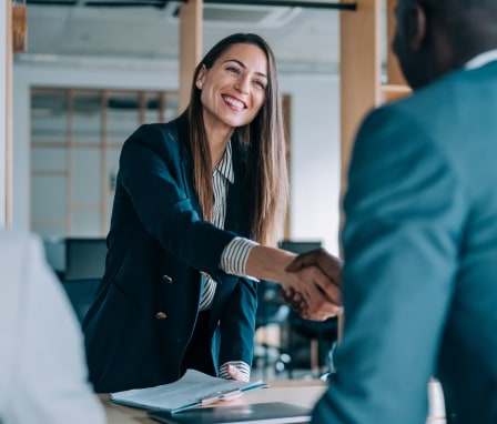 Business colleagues smiling and shaking hands