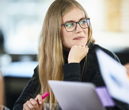 Woman in meeting listening to colleague