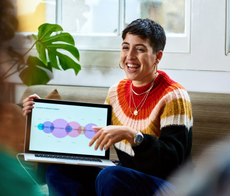 Business person showing laptop in meeting