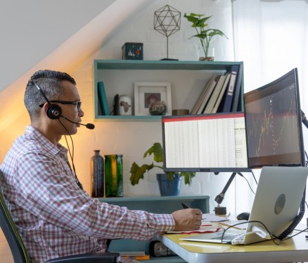 Man working on spreadsheets and graphs on a computer
