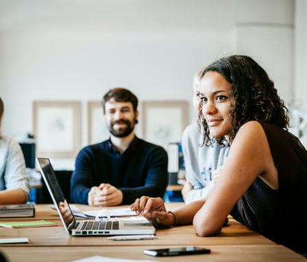 Young woman with a laptop in a business meeting