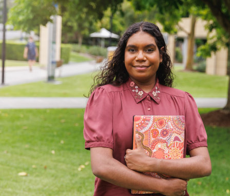 Woman student holding laptop