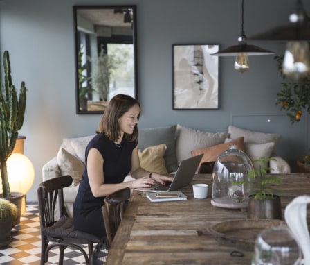 Woman working on laptop in home office