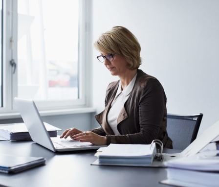 Woman working on laptop in a business office