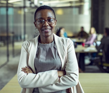 Women dressed professionally smiling in office building