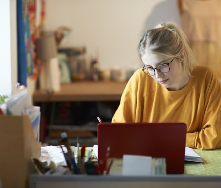 Young woman studying at a desk on a laptop