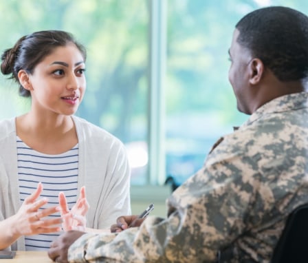 Woman talking to military officer