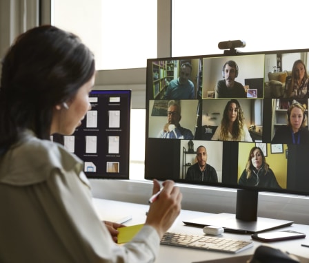 Woman on a video call with multiple people on desktop computer