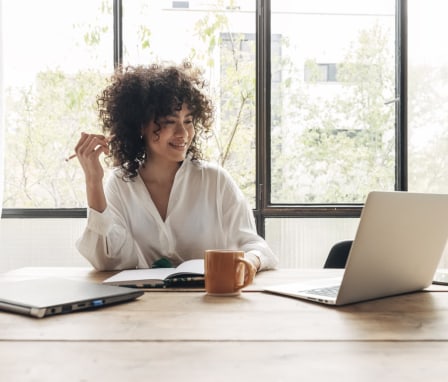 Young woman online student on laptop