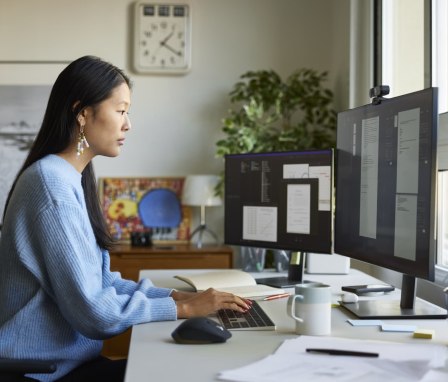 Woman working on desktop computer in home office