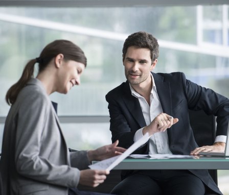 Two professionals meeting and reviewing papers
