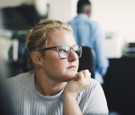 Woman looking stressed at work in an office