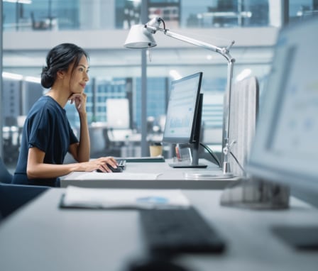 Woman using desktop computer in office